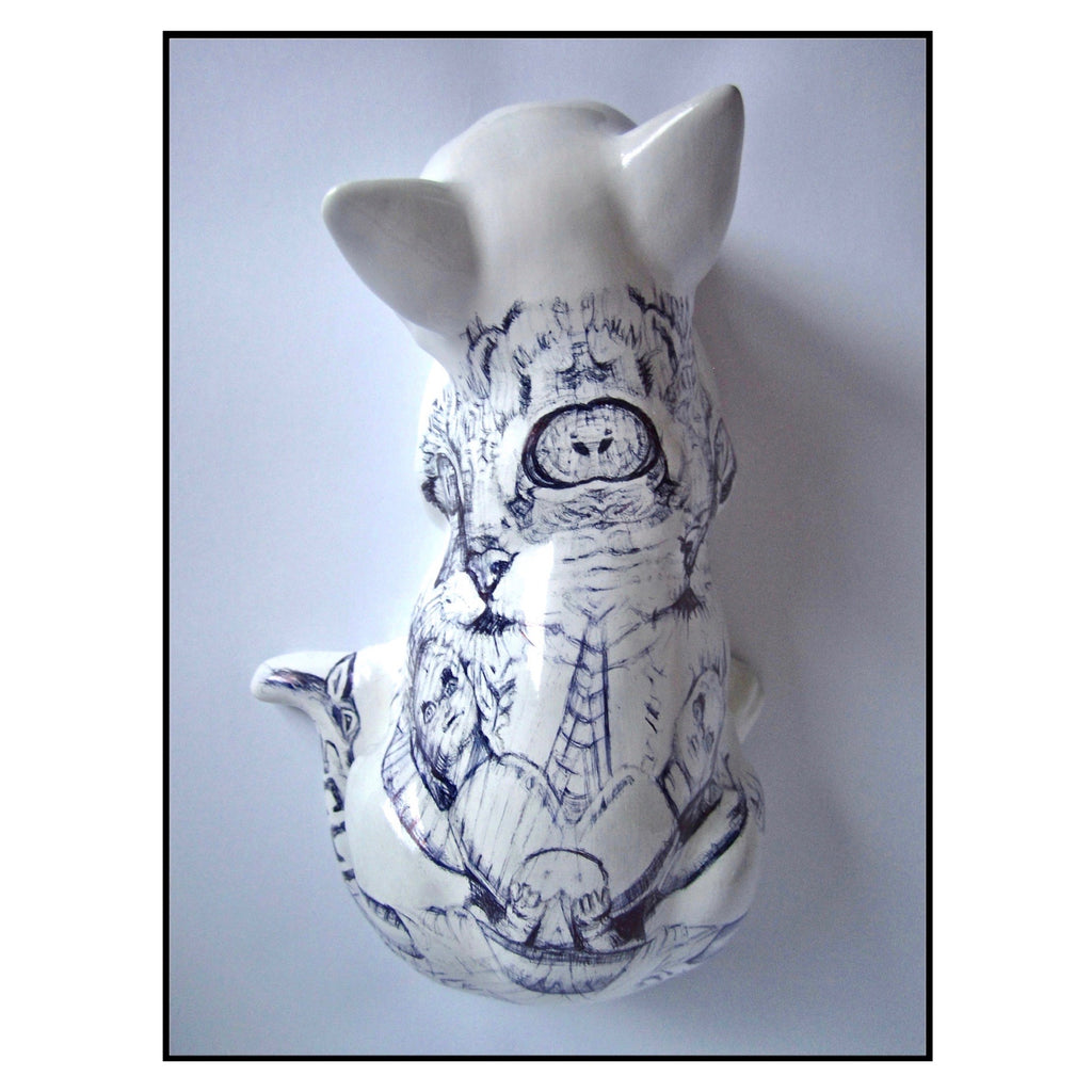 China cat figurine with a Biro drawing of cats and dolls